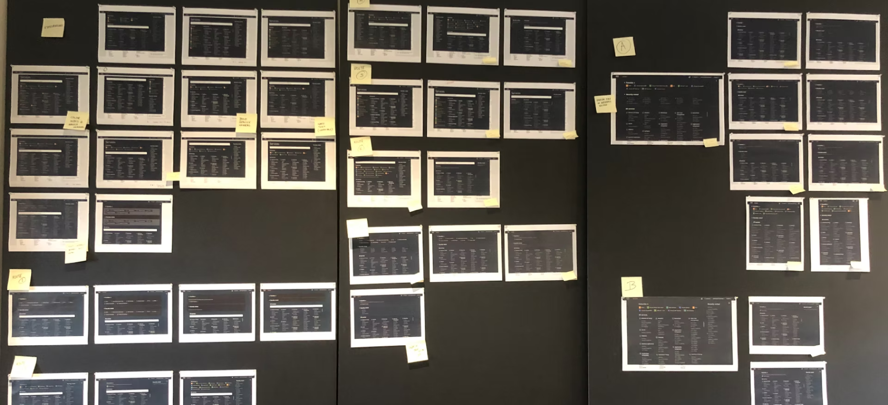 Printed concepts pinned to a review wall